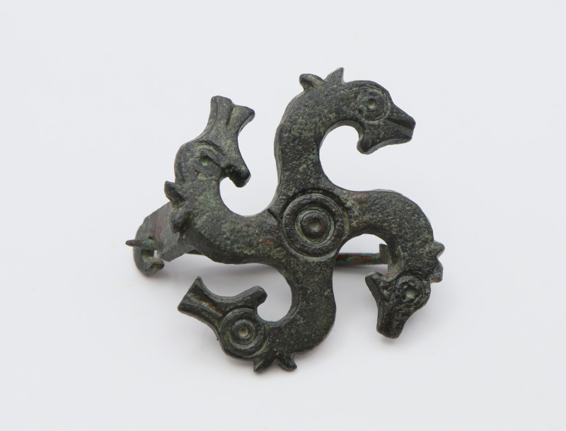 Formed as four profile horseheads emanating from a central roundel; each head wi...