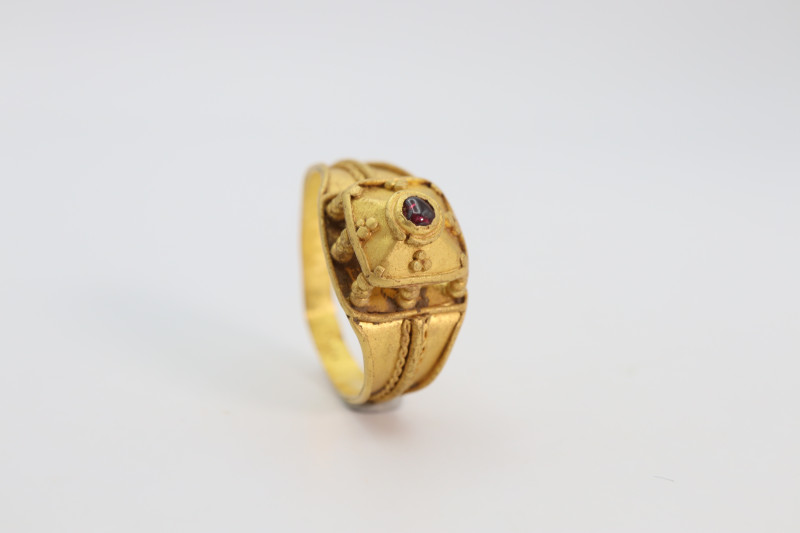 A gold finger ring with flat section band with overall phelegree decoration, enl...