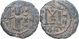 Umayyad Caliphate. Arab-Byzantine coinage (Pseudo-Byzantine type). AE Fals, Emesa mint, c. 660-680. D/ Caliph standing facing, holding scepter and glo...