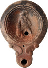 Roman Oil Lamp with Gladiator; Roman Oil Lamp with Gladiator, ca. 1st-2nd Century AD. Helmeted gladiator lunging, shield held low before him. Filling ...