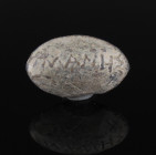 Greek sling bullet with inscription 'MANES / EYAR and MANES / PANTAR'