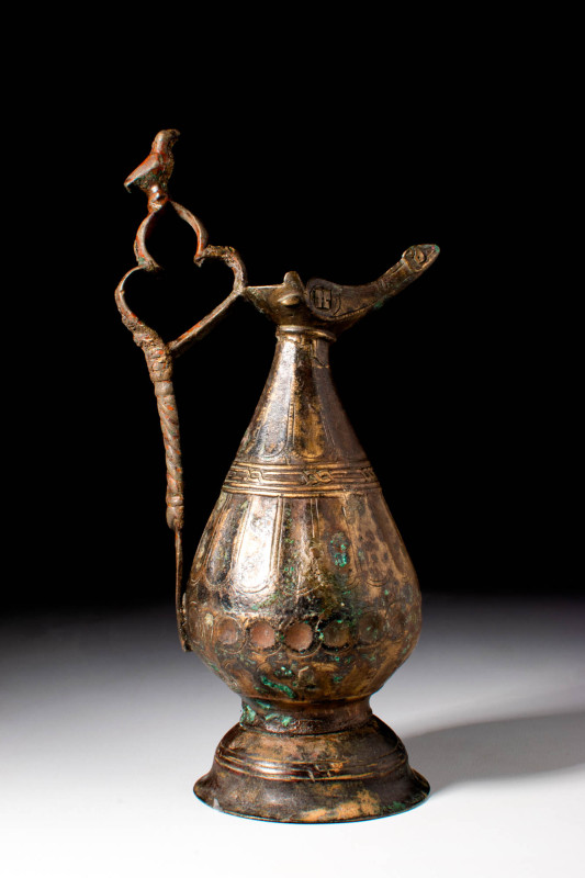 SELJUK BRONZE EWER WITH LAMP-SHAPED SPOUT

 Ca. AD 1000 - 1200 A Seljuk bronze...