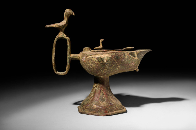 SELJUK BRONZE OIL LAMP

 Ca. AD 1000 - 1200 A Seljuk bronze oil lamp embellish...