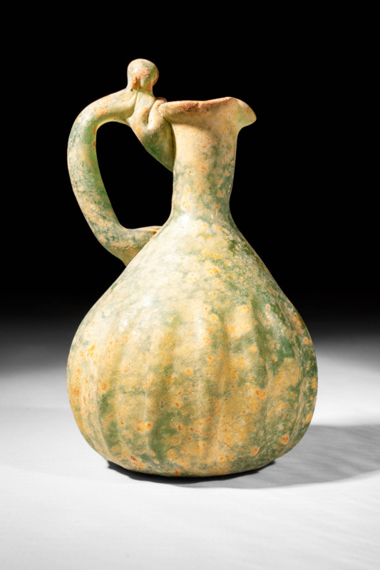 ABBASID RIBBED GLASS JUG

 Ca. AD 800 - 1000 An Abbasid green glass jug with p...