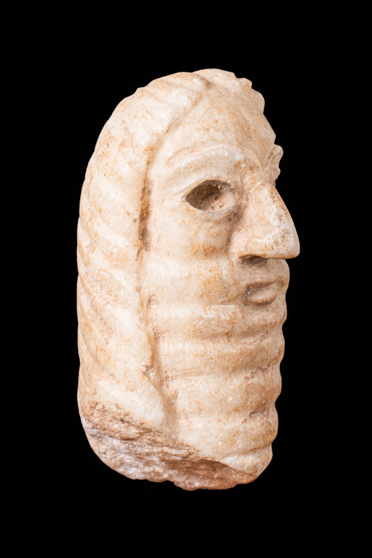 SUMERIAN STONE HEAD OF WORSHIPPER WITH LONG BEARD

 Ca. 2400 - 1800 BC A sculp...