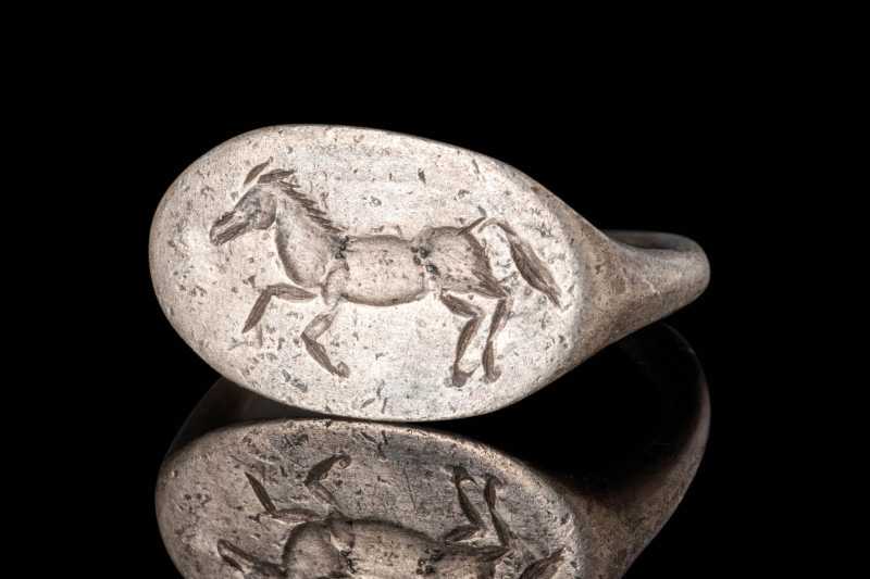 GREEK SILVER RING WITH A RUNNING HORSE

 Ca. 300 - 100 BC A Greek silver ring ...