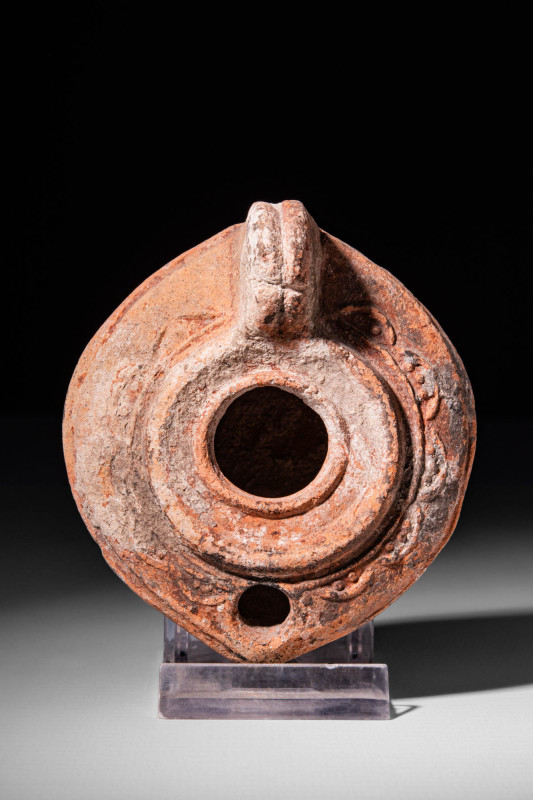 GREEK TERRACOTTA OIL LAMP

 Ca. 300 - 200 BC A Greek oil lamp with a large hol...