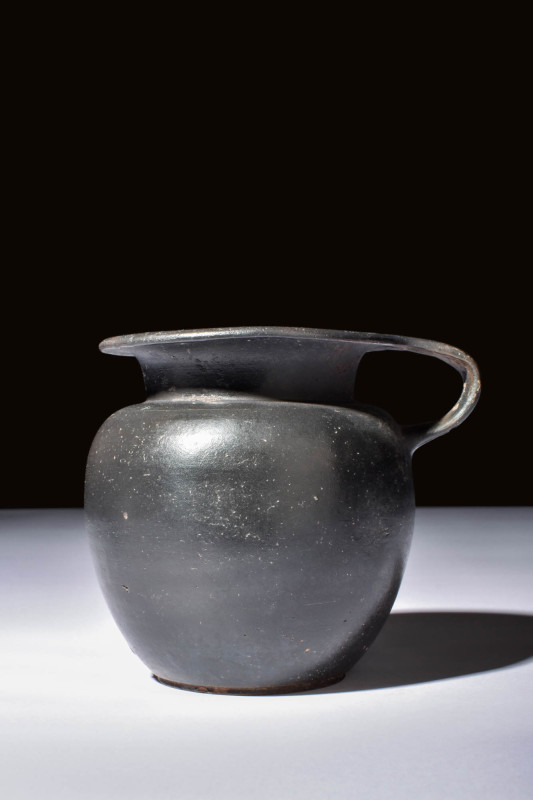 ATTIC BLACK-GLAZED OLPE WITH HANDLE

 Ca. 450 BC A black glazed olpe with a bu...