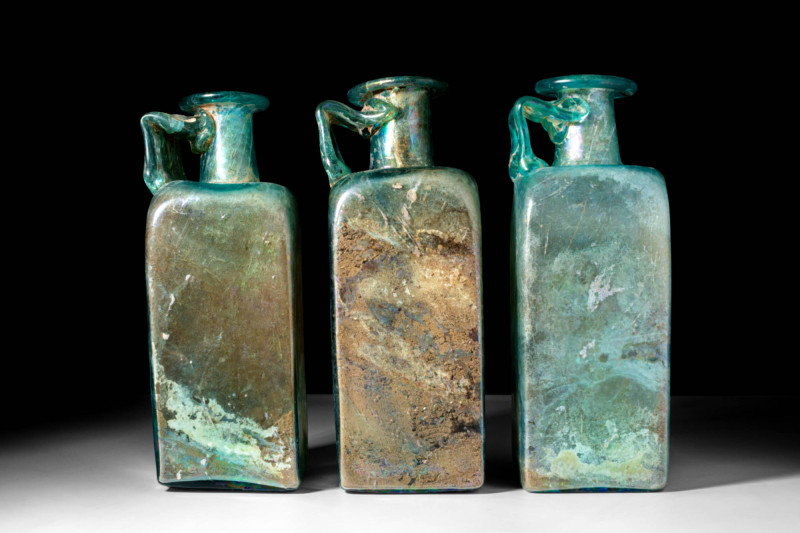 COLLECTION OF ROMAN GREEN GLASS BOTTLES

 Ca. AD 100 - 400 A collection of thr...