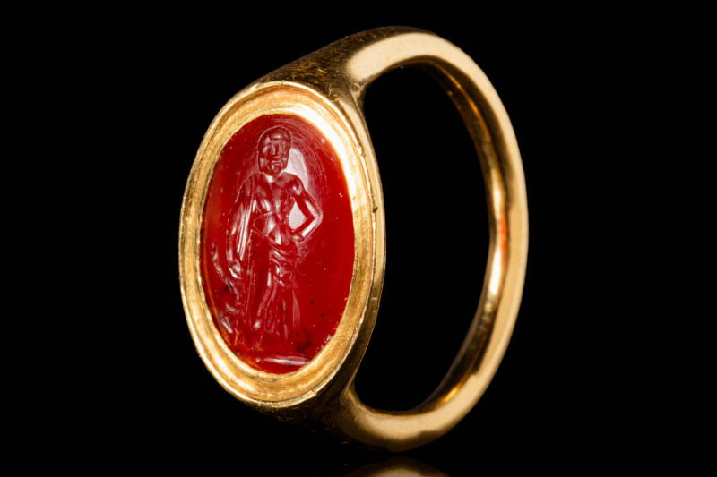 ROMAN CARNELIAN INTAGLIO DEPICTING ASCLEPIUS IN GOLD RING

 Ca. AD 100 - 300 A...