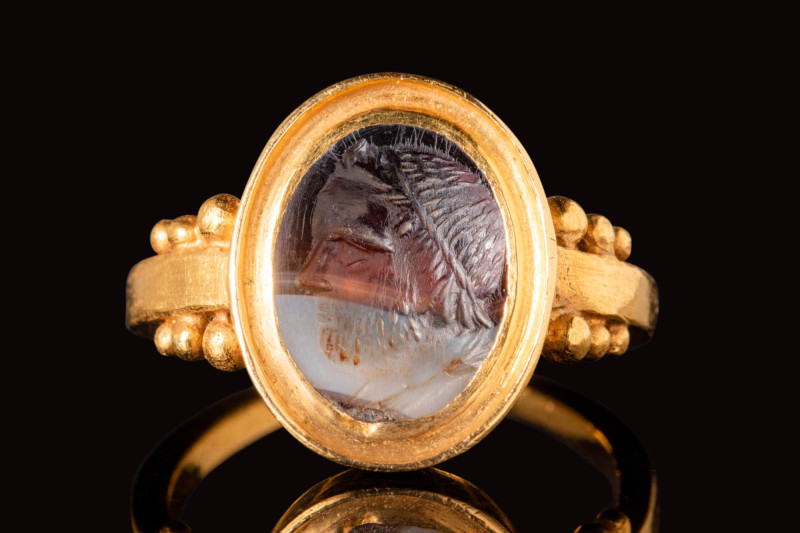 ROMAN BANDED AGATE INTAGLIO DEPICTING JUPITER IN GOLD RING

 Ca. AD 100 - 300 ...