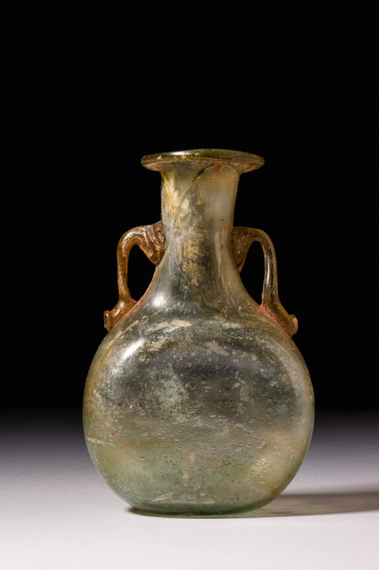 ROMAN GLASS AMPHORISKOS

 Ca. AD 100 - 300 A Roman free-blown pale green glass...