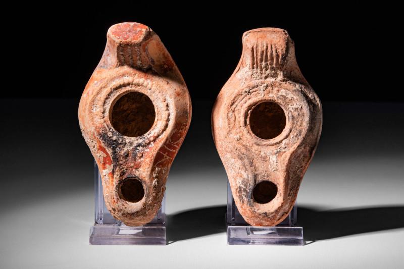 PAIR OF TERRACOTTA OIL LAMPS WITH DECORATED HANDLES

 Ca. AD 400 - 500 A pair ...