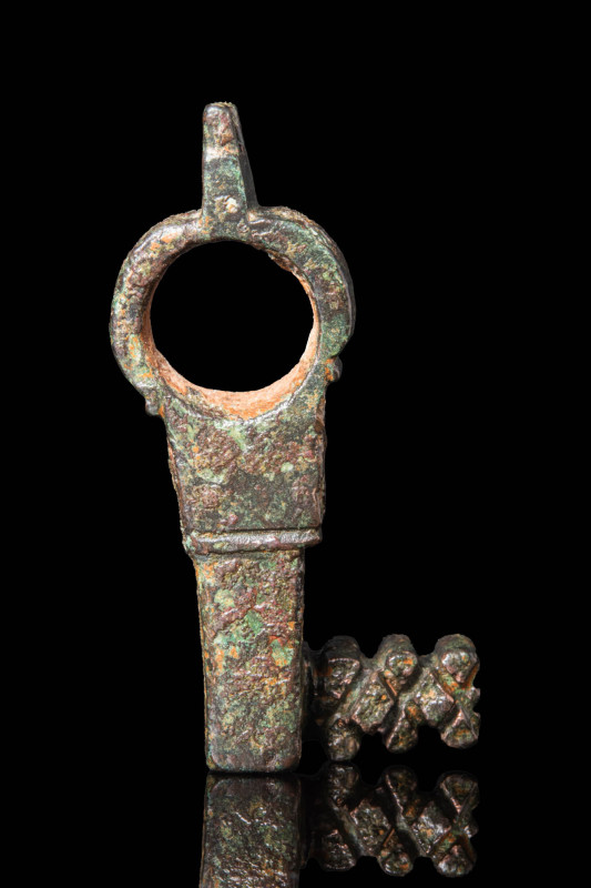 ROMAN BRONZE KEY RING

 Ca. AD 100 - 300 A Roman cast bronze key with a loop r...