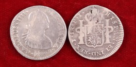 1798 y 1804. Carlos IV. México y Potosí. 1 real. 2 monedas, una con perforación reparada. BC-/BC.