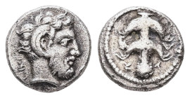 Kyrenaika, Kyrene. AR Obol, 0.62 g 8.59 mm. Circa 480-435 BC. 
Obv: Head of Zeus Ammon right. 
Rev:Silphium plant, all within a raised circle in an in...