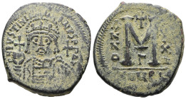 Justinian I, AD 527-565. AE, Follis. 19.07 g. 34.12 mm. Theoupolis (Antioch.). 
Obv: DN IVSTINI-ANVS PP AV. Helmeted and cuirassed bust facing, holdin...