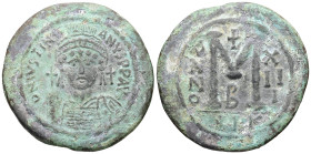Justinian I, AD 527-565. AE, Follis. 30.56 g. 43.10 mm. Nicomedia.
Obv: DNIVSTINI-ANVS PPAVC. Frontal bust of Justinian I wearing helmet with plume, d...