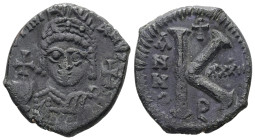 Justinian I, AD 527-565. AE, Half Follis. 9.67 g. 25.76 mm. Theoupolis (Antioch).
Obv: Helmeted, cuirassed bust facing, holding cross on globe and lon...