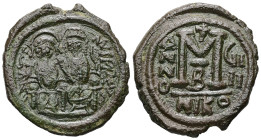 Justin II and Sophia. AD 565-578. AE, Follis. 12.82 g. 30.46 mm. Nicomedia. 
Obv: DNIVSTI-NVSPPAVC. Justin II on left and Sophia on right, seated, nim...