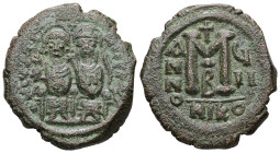 Justin II and Sophia. AD 565-578. AE, Follis. 13.10 g. 29.82 mm. Nicomedia.
Obv: DNIVSTI-NVSPPAVC. Justin II on left and Sophia on right, seated, nimb...