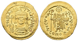 Maurice Tiberius, AD 582-602. AV, Solidus. 4.26 g. 21.28 mm. Constantinople.
Obv: DN MAVRC-TIbPPAVC. Frontal bust of Maurice in cuirass and helmet wit...