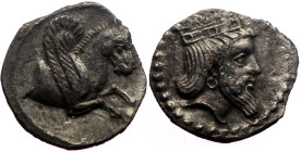 Cilicia, Uncertain mint AR Obol (Silver, 0.64g, 11mm) ca 350 BC. 
Obv: Bearded male head to right, wearing a curved-topped crown and a hoop earring; b...