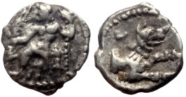 Lycaonia, Laranda AR Obol (Silver, 0.46g, 10mm) ca 324/3 BC. 
Obv: Baaltars seated left, torso facing, holding grain ear and grape bunch in extended r...