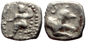 Lycaonia, Laranda AR Obol (Silver, 0.56g, 11mm) ca 324/3 BC. 
Obv: Baaltars seated left, torso facing, holding grain ear and grape bunch in extended r...