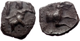 Lycaonia, Laranda AR Obol (Silver, 0.52g, 9mm) ca 324/3 BC.
Obv: Baaltars seated left, torso facing, holding grain ear and grape bunch in extended ri...