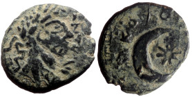 Mesopotamia, Carrhae AE (Bronze, 2.03g, 13mm) Commodus, 180-192. 
Obv: Laureate head right 
Rev: Crescent and star over cushion-like object, blundered...