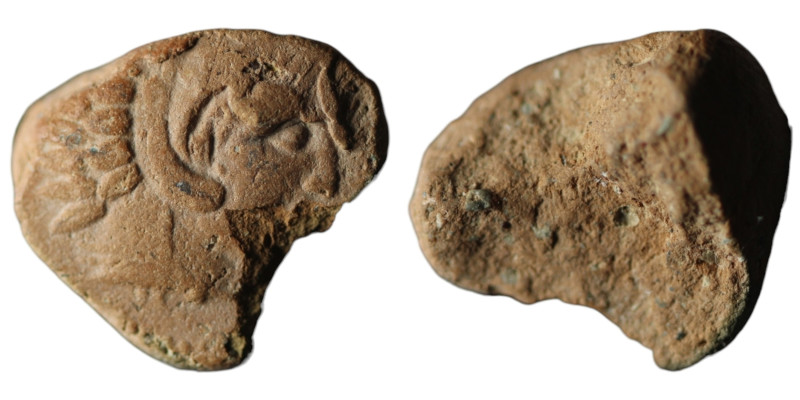 Terracotta 
(17mm, 0,94g)
Obv: Head of Herakles to right, wearing lion skin head...