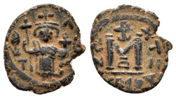 ARAB BYZANTINE.Dimashq (Damascus). Standing Caliph.(692-697).Fals.

Obv : Byzantine style standing emperor, holding long cross and globus cruciger; ...