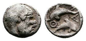 Islands off Thrace, Thasos, circa 412-404 BC. AR Tritartemorion (8 mm. 0,41 g). Bald and bearded head of satyr to right. Rev. ΘΑΣ Two dolphins, one ab...