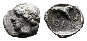 Islands off Thrace, Thasos, circa 412-404 BC. AR Hemiobol (7 mm, 0.22 g.). Head of nymph to left. Rev. ΘΑΣ Dolphin swimming to left. HGC 6, 341. Le Ri...