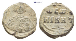 Byzantine Lead Seal (18mm, 5.61 g) Facing bust of a bearded Saint wearing nimbus. Rev. Legends in three lines.