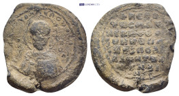 Byzantine Lead Seal (34mm, 21.68 g) Nimbate facing bust of Saint Nicholas, raising his right hand in benediction and holding book of Gospels in his le...