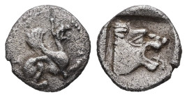 Troas, Assos. AR Hemiobol, 0.50 g 9.57 mm. Circa 500-450 BC.
Obv: Griffin seated to right, raising forepaw
Rev: Head of roaring lion to right within s...