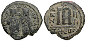 Phocas and Leontia, AD 602-610. AE, Follis. 9.66 g. 28.81 mm. Theoupolis (Antioch).
Obv: Phocas standing to left, crowned and holding globus cruciger ...