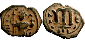 Constans II (641-668) Follis. Obverse: Imperial figure holding cross and globus Reverse: m and inscription
16mm 2,69g

Artificial sand patina