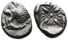 MiletusObol circa 500-494, AR . Forepart of lion r., head looking backwards, with open jaws and tongue protrudring. Rev. Floral pattern in incuse squa...