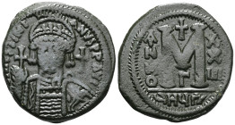 ByzantineJustinian I (527-565) AE Follis (Bronze) Antioch.Obv: DN IVSTINIANVS PP AVG, helmeted and cuirassed bust facing, holding cross on globe and s...
