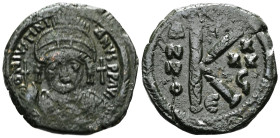 JUSTINIAN I (527-565). Half Follis. Constantinople.Obv: D N IVSTINIANVS P P AVG.Helmeted and cuirassed bust facing, holding globus cruciger and decora...