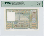 MOROCCO: 1000 Francs (15.11.1956) in multicolor. Mosque, city and hills in background on face. S/N: "V.20 08021". WMK: Lion head. Inside holder by PMG...