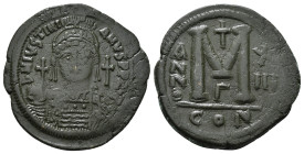 JUSTINIAN I (527-565). Follis.
Obv: D N IVSTINIANVS P P AVG.
Helmeted and cuirassed bust facing, holding globus cruciger and shield decorated with hor...