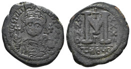 JUSTINIAN I (527-565). Follis.
Obv: D N IVSTINIANVS P P AVG.
Helmeted and cuirassed bust facing, holding globus cruciger and shield decorated with hor...