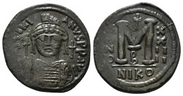 JUSTINIAN I (527-565). Follis.
Obv: D N IVSTINIANVS P P AVG.
Helmeted and cuirassed bust facing, holding globus cruciger and shield decorated with hor...