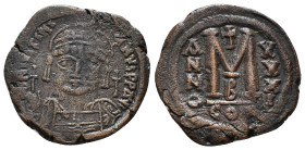 JUSTINIAN I (527-565). Follis.
Obv: D N IVSTINIANVS P P AVG.
Helmeted and cuirassed bust facing, holding globus cruciger and shield decorated with hor...