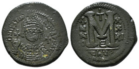 JUSTINIAN I (527-565). Follis.
Obv: D N IVSTINIANVS P P AVG.
Helmeted and cuirassed bust facing, holding globus cruciger and shield decorated with hor...