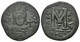 JUSTINIAN I (527-565). Follis.
Obv: D N IVSTINIANVS P P AVG.
Helmeted and cuirassed bust facing, holding globus cruciger and shield decorated with hor...